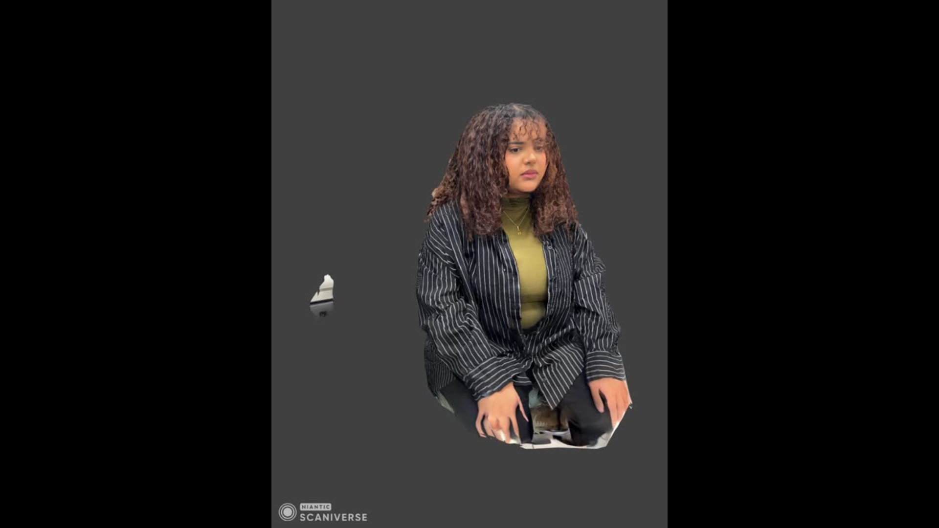 This image shows the 3D scan of me sitting down, captured in Scaniverse. The scan mainly kept the front of my body and clothes, but a lot of the background and edges did not fully render.