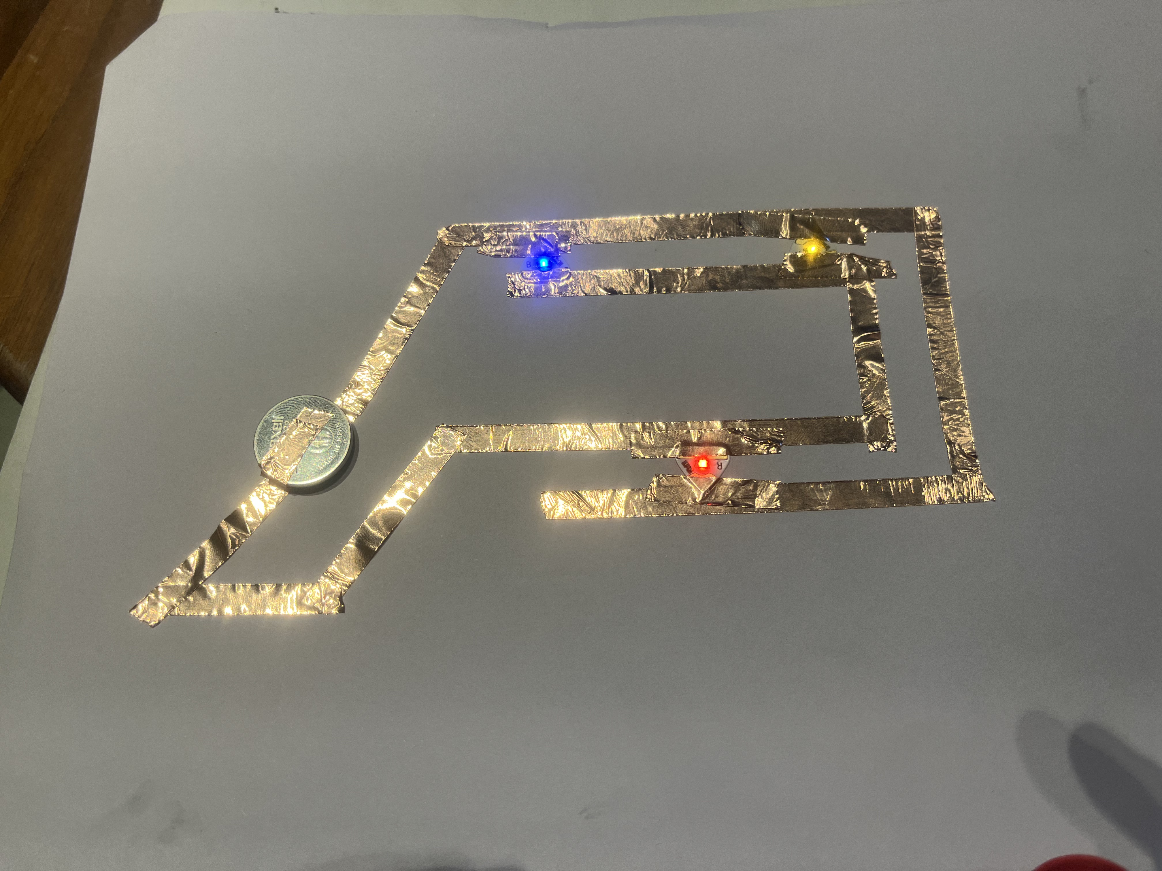 I wanted to create a parallel circuit. I have two main vertical copper tape paths which power the three led's.