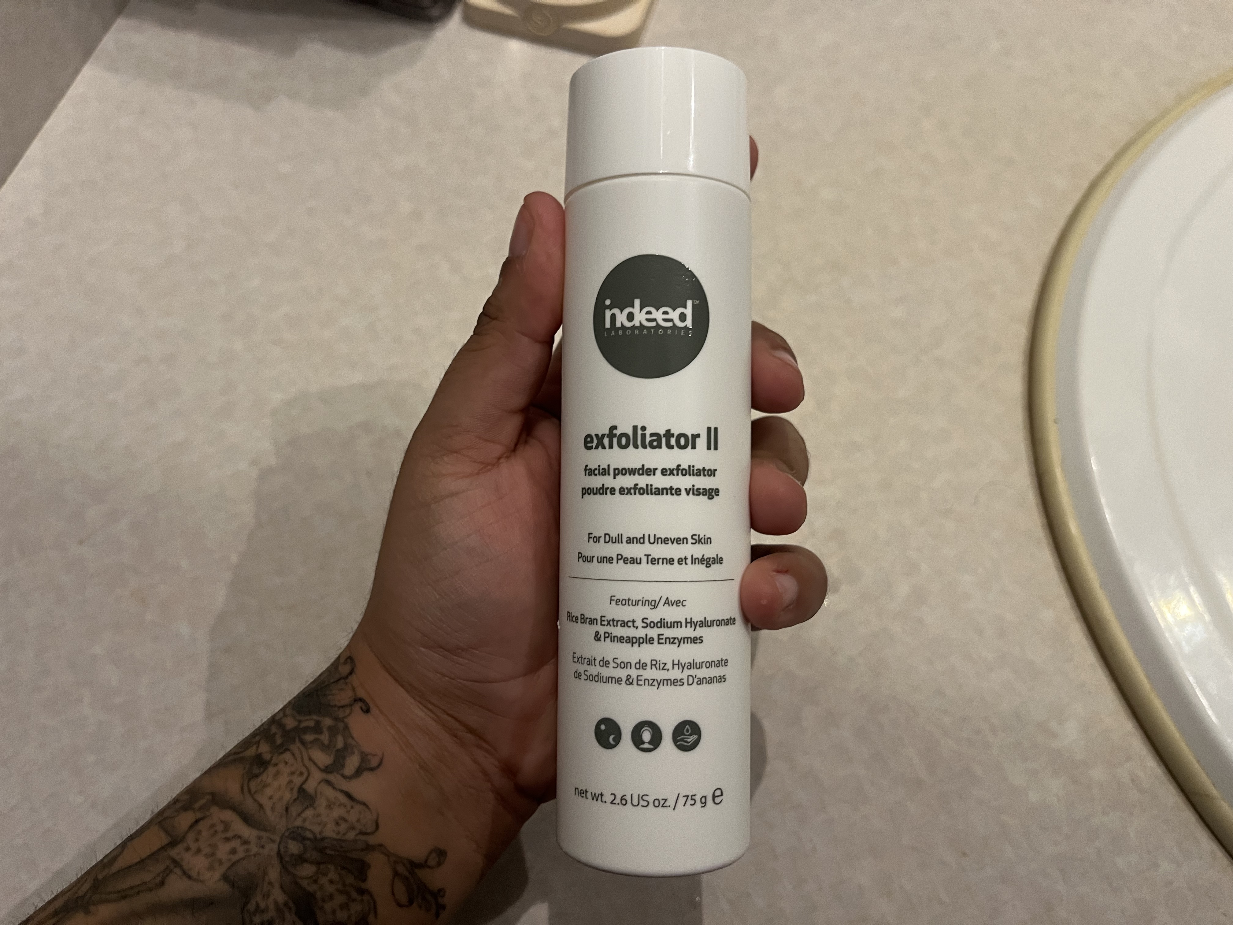 This is the sound of the powder cleanser being shaken up and down, creating a soft, dry rattling noise as the powder shifts inside the container.