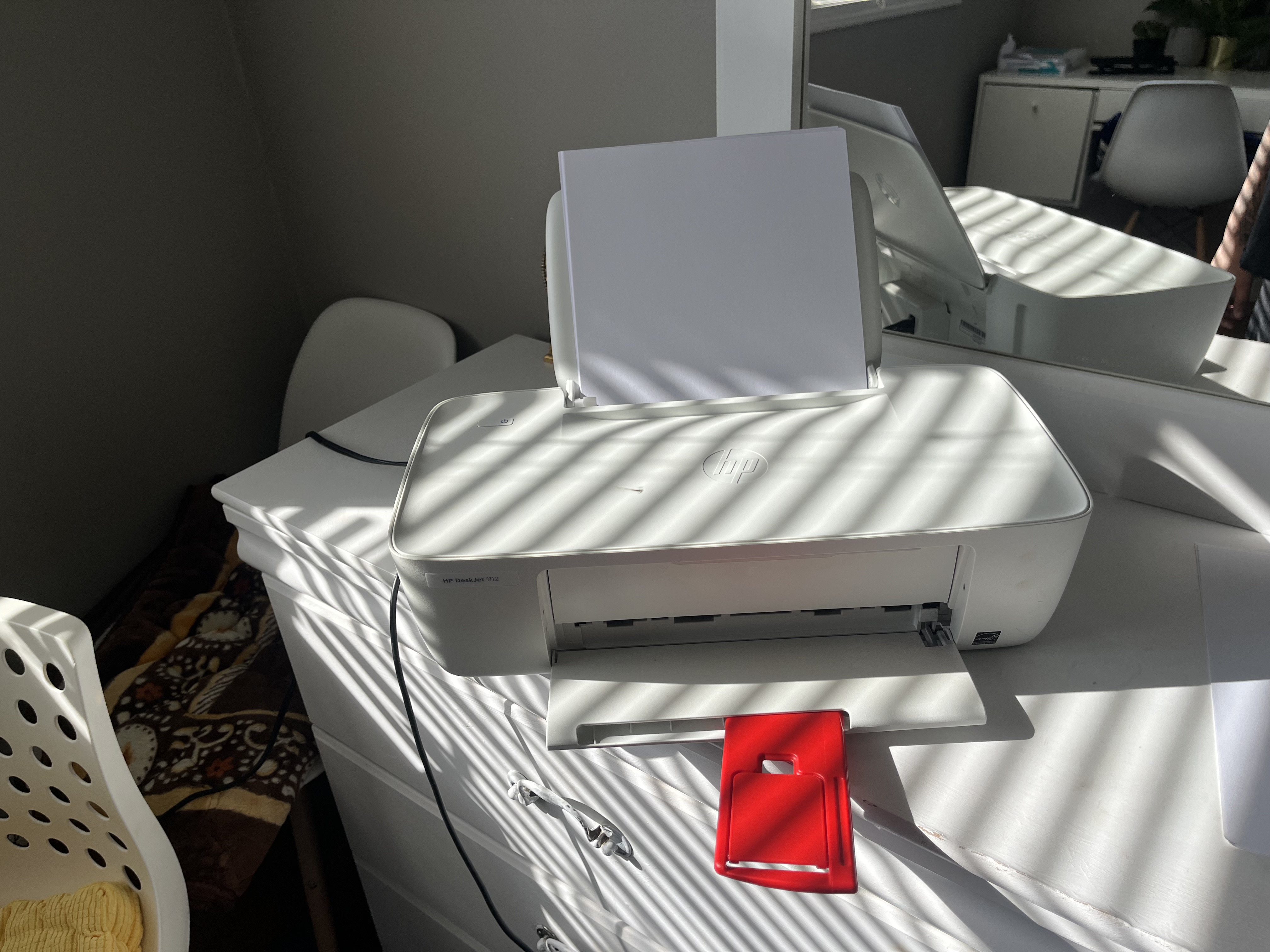 This is the sound of the printer printing, producing a steady mechanical whirring with rhythmic clicking and rolling noises as the paper feeds through.