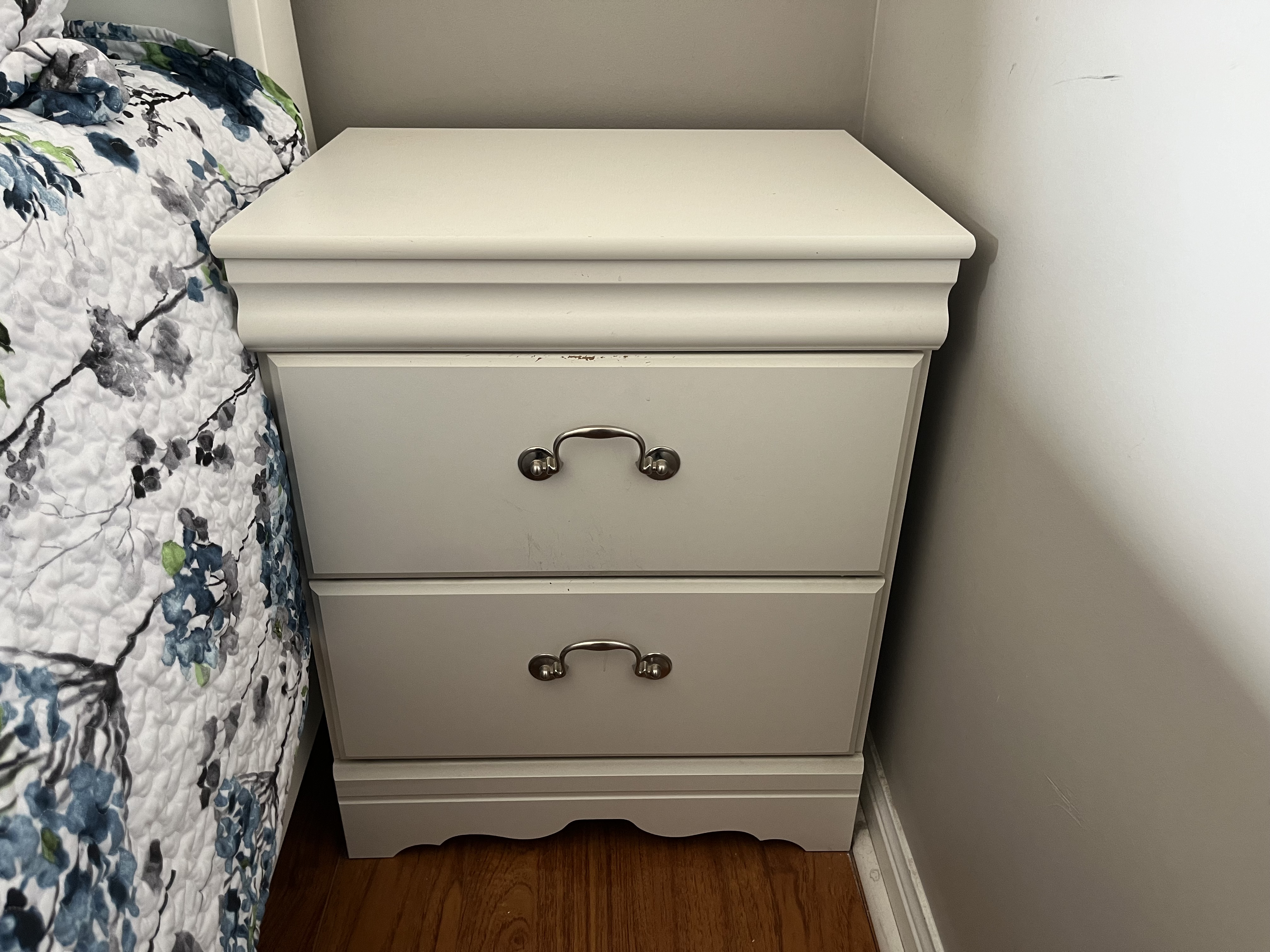 This is the sound of a bedside drawer being opened and then shut, with a soft sliding motion followed by a gentle close.